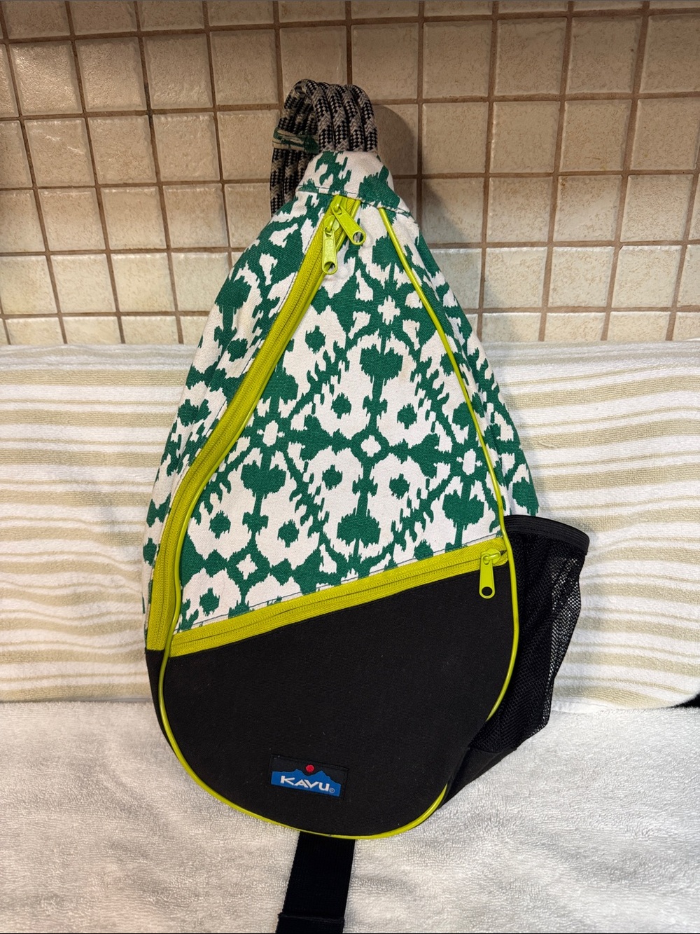 Kavu Green Ikat Sling Backpack with Black Panel and Yellow Zippers